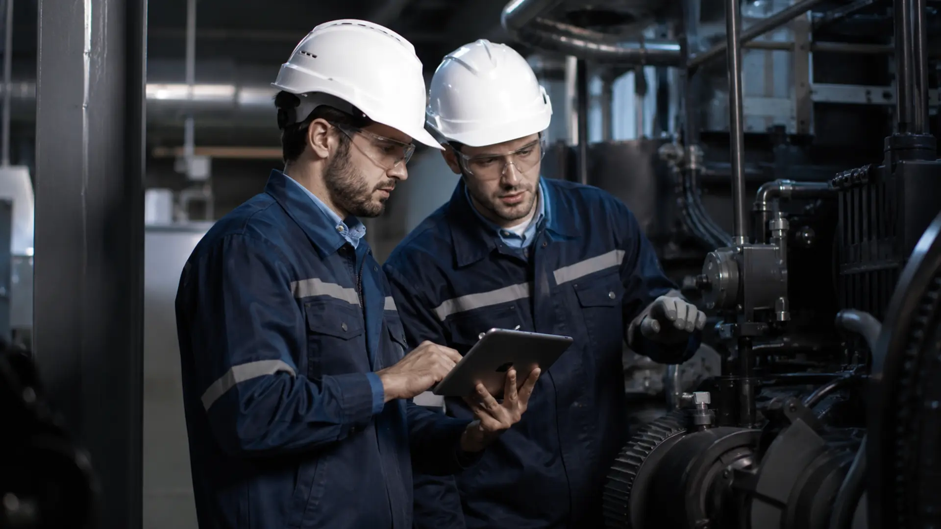 Engineers inspecting industrial machinery